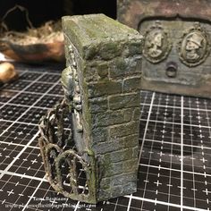 a stone block with chains attached to it sitting on a table next to other items