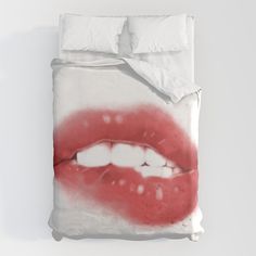 a white bed with red lips on it