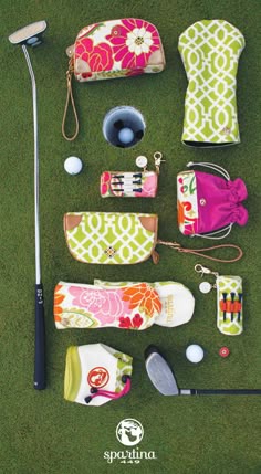 various golf accessories laid out on the grass