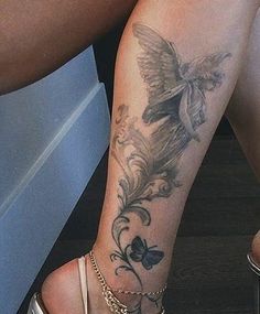 a close up of a person's legs with tattoos on them