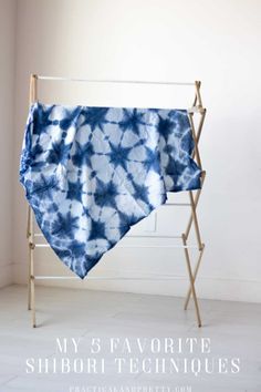 a blue and white tie - dyed towel hanging on a clothes rack