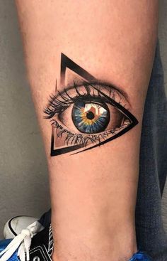 an eye tattoo on the leg