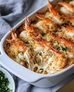 a casserole dish with shrimp and parmesan cheese