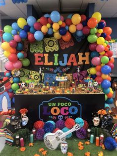 an elaborate display with balloons and decorations for mexican day of the dead celebration in a store