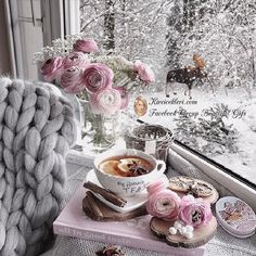 a cup of coffee and some doughnuts on a window sill