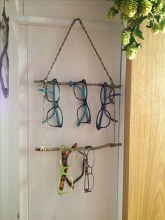 several pairs of glasses hanging on a wall