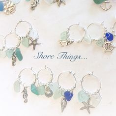 there are many different charms on the table with words shore things written below them and an image of a starfish