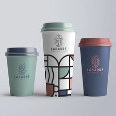 three different types of coffee cups sitting next to each other on a gray surface with the same logo