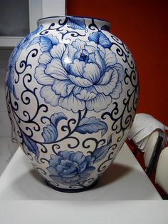 a blue and white vase sitting on top of a table