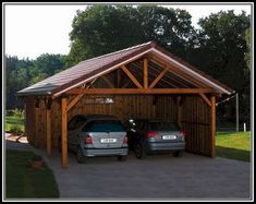 two cars parked in front of a wooden garage