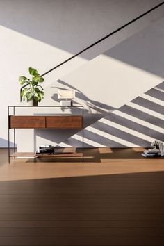 a table with a plant on it in the middle of a room