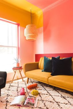 a living room with orange and pink walls