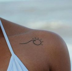 a woman with a small tattoo on her shoulder