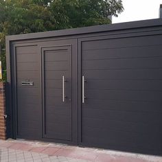 an image of a modern style garage with double doors and brick walkway leading to it