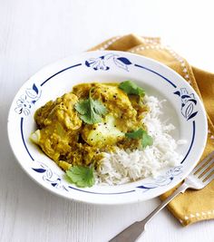 a white plate topped with rice and curry