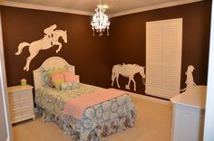 a bedroom with horse decals on the wall