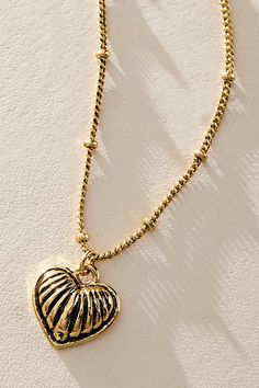 The true definition of an effortless essential, this 14k gold plated necklace features a ball-adorned metal chain with ribbed heart pendant at center for a forever classic, femme finishing touch. * Pendant style * Adjustable fit * Lobster clasp closure * 14k gold plated | Love Song 14k Gold Plated Necklace by Free People in Gold Love Song, Gold Plated Necklace, Clothes Gift, Metal Chain, Boho Outfits, Our Love, Heart Pendant, Love Songs, Lobster Clasp