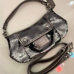 Coach Poppy Limited Edition Silver Sequin Groovy Crossbody Bag #15381 - Style: Crossbody/Satchel - Material: Graphite Grey Silver Sequins With Leather Trim Silver Hardware - Closure: Zip-Top - Inside Zip And Multifunction Pockets - Exterior Front Pocket Kept Closed With Hidden Magnetic Snap - Fabric Lining. - Approx. 11" (L) X 6.75" (H) X 4" (W) - 100% Authentic New Without Tags Chic Coach Party Bag, Chic Party Bags By Coach, Elegant Coach Shoulder Bag For Party, Luxury Coach Bag For Party, Luxury Coach Party Bag, Luxury Coach Party Bags, Crossbody Satchel, Coach Poppy, Bags Coach