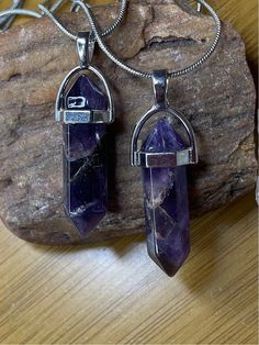 These are beautiful amethyst crystal point necklaces. They have a hexagonal cut.  Each pendant is 1.5 inches in height on a silver plated 18 inch chain. Amethyst is a beautiful purple stone with flecks of silvery grays. Each piece has a lot of dimension and unique markings characteristic of Amethyst stones. Crystal Point Necklace, Wardrobe Wishlist, Amethyst Stones, Purple Stones, Amethyst Stone, Crystal Points, Amethyst Crystal