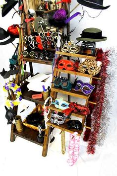 a shelf filled with lots of different types of hats and eyewear on top of each other