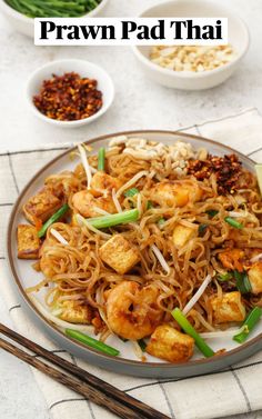 praw pad thai noodles on a plate with chopsticks