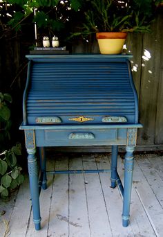 several pictures of an old blue piano and potted plant on the side of it