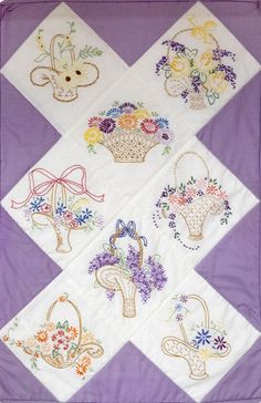 a quilted wall hanging with flowers and baskets on it's diagonal diamond pattern