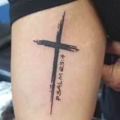 a person with a cross tattoo on their leg