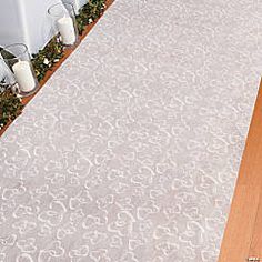 a white rug sitting on top of a wooden floor next to a table and chairs