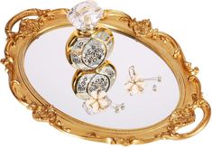 an ornately decorated tray with three rings and two butterflies on it, set against a white background