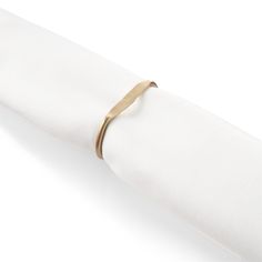 a napkin with a gold ring on it