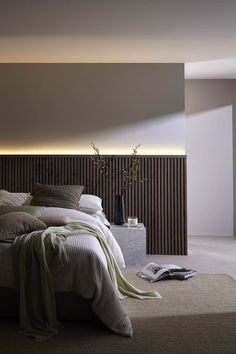 a large bed sitting next to a tall wooden headboard on top of a wall