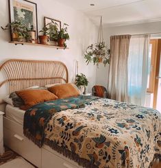 a bed in a bedroom with plants on the headboard