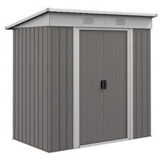 a gray and white storage shed with the door open to show it's side