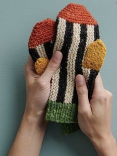 someone is holding up a knitted mitt that has been made to look like a hat