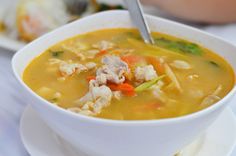 a white bowl filled with soup on top of a table