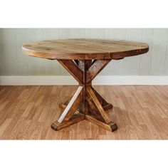 a wooden table sitting on top of a hard wood floor