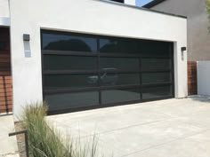 a garage door is open in front of a house