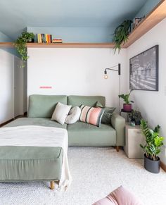 a living room filled with furniture and plants