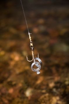 a fishing hook hanging from the side of a rope