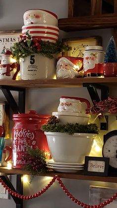 christmas decorations are displayed on shelves in the kitchen