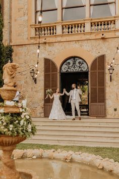 a bride and groom are walking out of the entrance to their wedding ceremony in italy