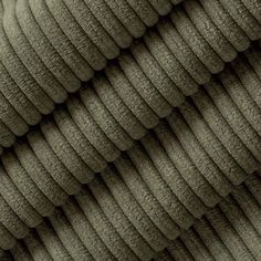 the texture of an upholstered fabric is shown in dark olive green color, with wavy lines on it