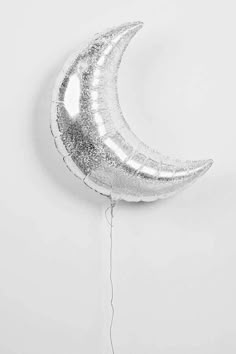 a balloon shaped like the moon hanging from a string