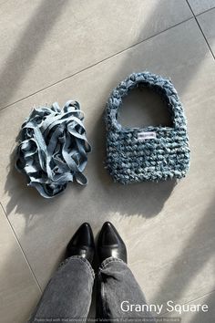 two pieces of cloth sitting on the floor next to each other, one blue and one gray