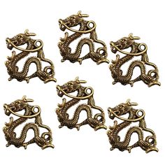 six brass dragon charms on a white background