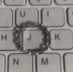 a ring sitting on top of a computer keyboard