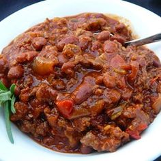 a white plate topped with meat and vegetables