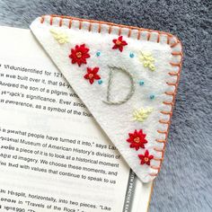 a close up of a bookmark with flowers on it