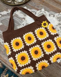 a brown and yellow bag sitting on top of a table next to a doily